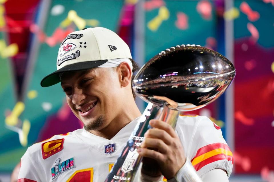 FILE -Kansas City Chiefs quarterback Patrick Mahomes (15) holds the trophy after their win against the Philadelphia Eagles in the NFL Super Bowl 57 football game, Sunday, Feb. 12, 2023, in Glendale, Ariz. For every example such as Kansas City's move to trade up for two-time MVP Patrick Mahomes in 2017 or Buffalo's decision the next year to move up for franchise quarterback Josh Allen, there are misses. (AP Photo/Matt Slocum, File)