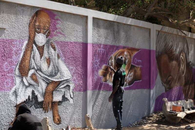 A graffiti artist from RBS crew works on his mural to encourage people to protect themselves amid the outbreak of the coronavirus disease (COVID-19), in Dakar