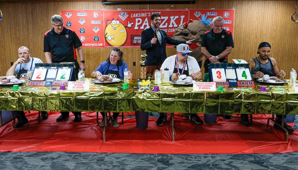 Contestants in the inaugural Quality Dairy paczki-eating contest are nearing the end of the three-minute contest Friday, Jan. 26, 2024. From left, Scott Lorms, Holly Mulligan, Jordan Weber, and the winner Akiem Harshman.
