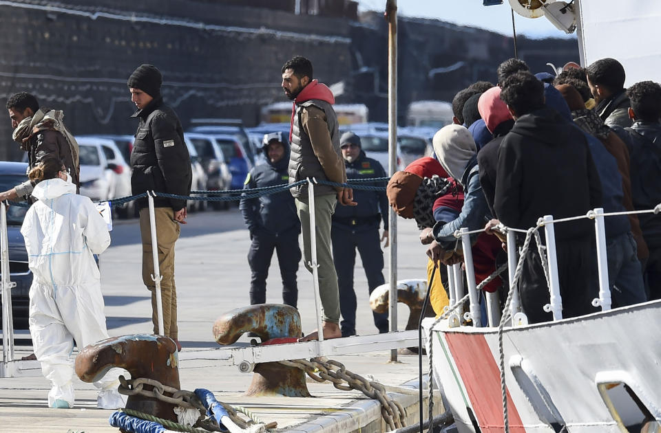 Some 300 migrants saved at sea are disembarked from the Italian coast guard ship Peluso in the Sicilian harbor of Catania, Italy, Monday, April 17, 2023. (AP Photo/Salvatore Cavalli)