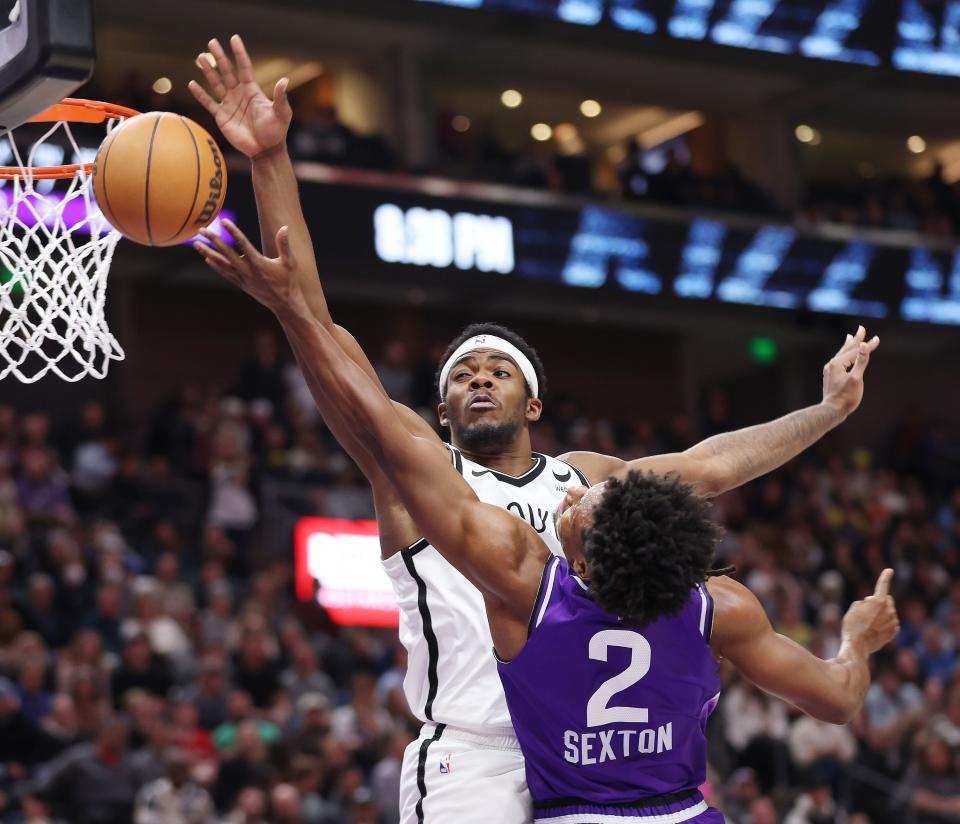 Utah Jazz guard Collin Sexton (2) tries to shoot by Brooklyn Nets center Day’Ron Sharpe (20) in Salt Lake City on Monday, Dec. 18, 2023. The Jazz won 125-108. | Jeffrey D. Allred, Deseret News