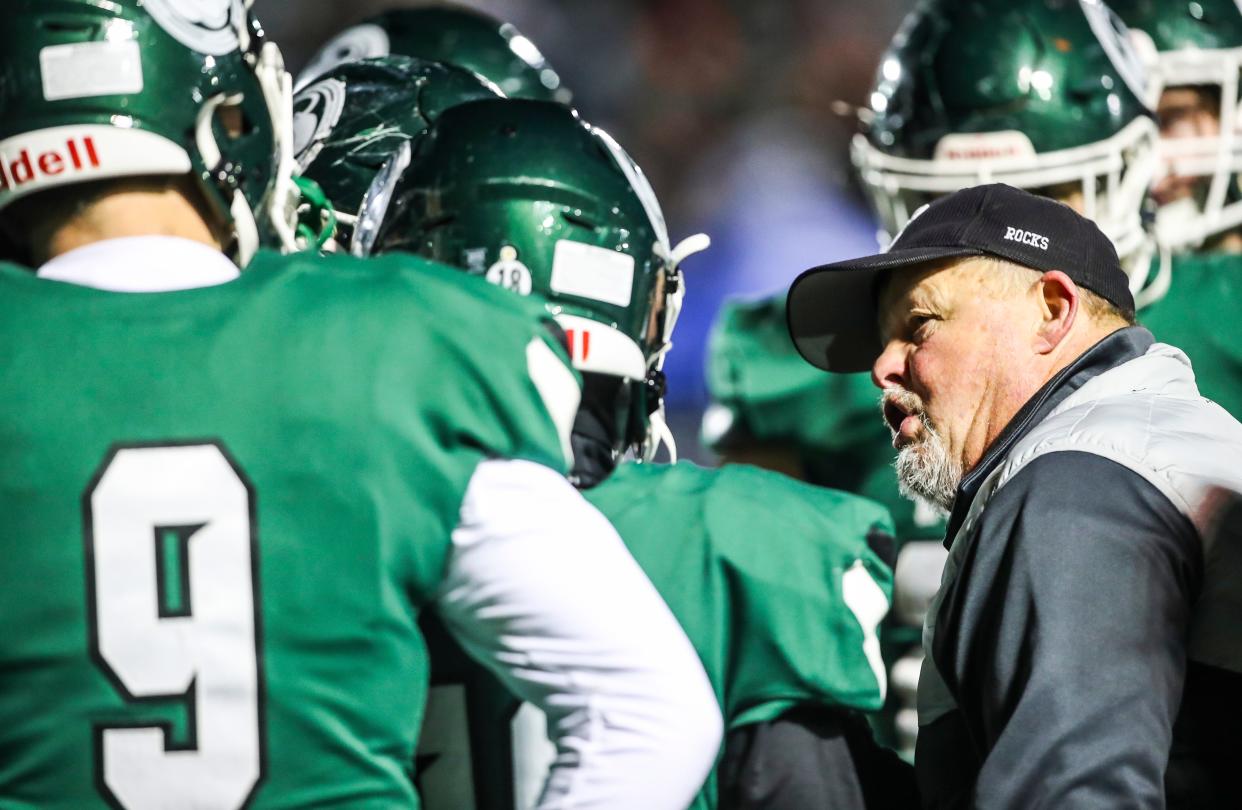 Trinity coach Jay Cobb talks with his team late in the fourth quarter. The Rocks defeated Frederick Douglass, 14-7, in overtime Friday night.