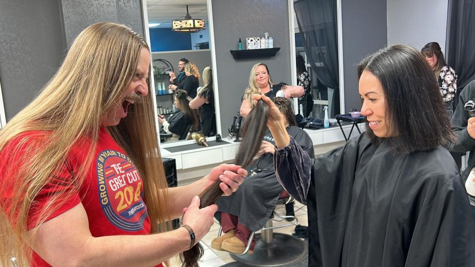 A member of The Longhairs is shown with a hair donor. The Longhairs is collecting hair donations for South Rockwood's Children with Hair Loss during March 16's The Great Cut. Donations also can be mailed.