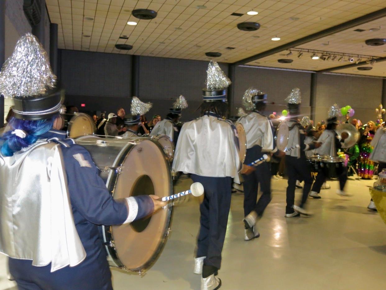 The Huntington High School Raider Jukebox Marching Band made a surprise appearance at the Twelfth Night Party.