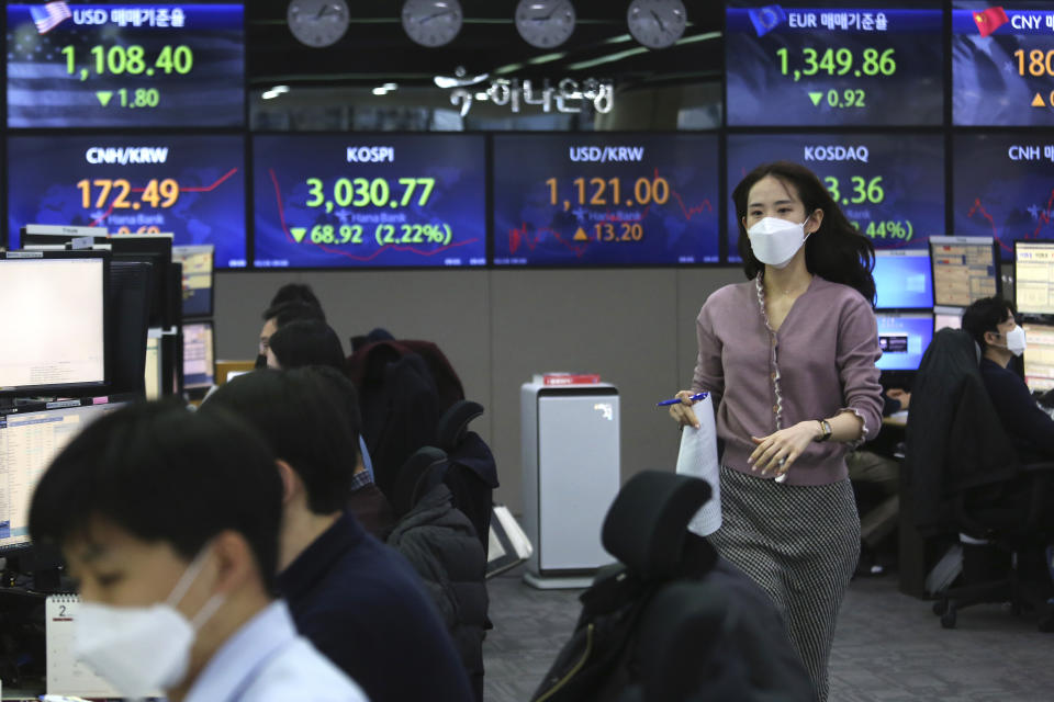 A currency trader runs at the foreign exchange dealing room of the KEB Hana Bank headquarters in Seoul, South Korea, Friday, Feb. 26, 2021. Asian shares skidded Friday after rising bond yields triggered a broad sell-off on Wall Street that erased the markets gain for the week and handed the Nasdaq composite index its steepest loss since October. (AP Photo/Ahn Young-joon)