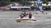 Rescue workers use boats to search for missing people in floodwaters in Gapyoeng, South Korea, Thursday, aug. 6, 2020. Torrential rains continuously pounded South Korea on Thursday, prompting authorities to close parts of highways and issue a rare flood alert near a key river bridge in Seoul. (Yang Ji-ung/Yonhap via AP)