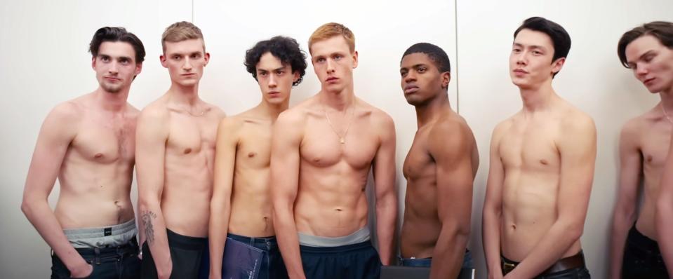 Harris Dickinson and a bunch of other models pose shirtless