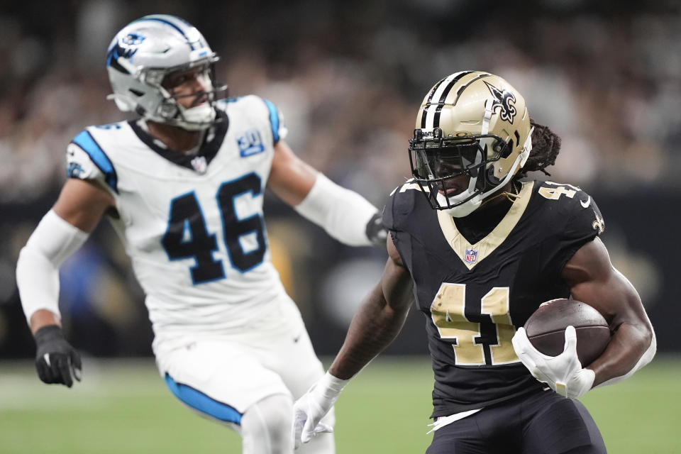 New Orleans Saints running back Alvin Kamara (41) runs the ball past Carolina Panthers linebacker Eku Leota (46) during the first half of an NFL football game Sunday, Sept. 8, 2024, in New Orleans. (AP Photo/Gerald Herbert)