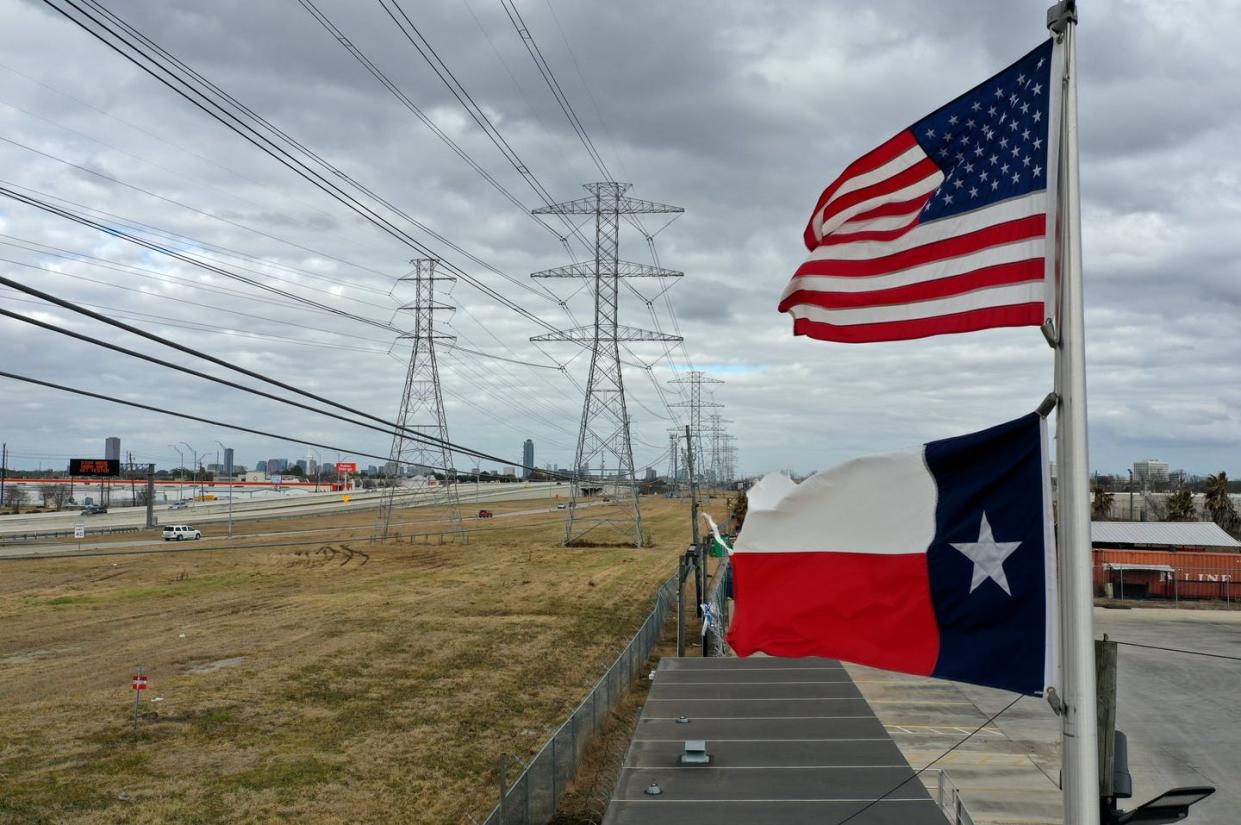 <span class="caption">Power to the people, but it will cost you.</span> <span class="attribution"><a class="link " href="https://www.gettyimages.com/detail/news-photo/the-u-s-and-texas-flags-fly-in-front-of-high-voltage-news-photo/1303397476?adppopup=true" rel="nofollow noopener" target="_blank" data-ylk="slk:Justin Sullivan/Getty Images;elm:context_link;itc:0;sec:content-canvas">Justin Sullivan/Getty Images</a></span>