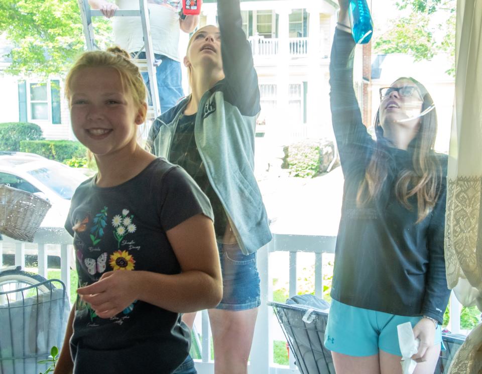 Some St. Charles volunteers washed windows at Tommy's House.