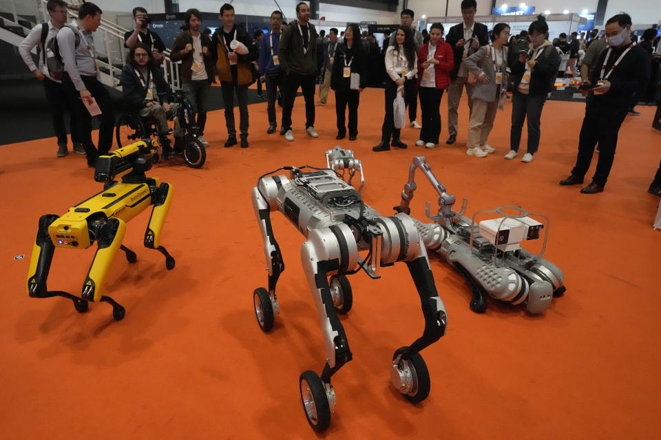 Robots perform, and interact with visitors during the International Conference on Robotics and Automation ICRA in London, Tuesday, May 30, 2023.The 2023 ICRA brings together the world's top academics, researchers, and industry representatives to show the newest developments. (AP Photo/Frank Augstein)