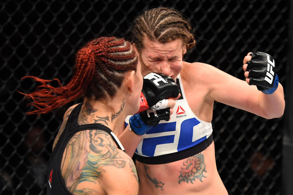 CURITIBA, BRAZIL - MAY 14:  (L-R) Cristiane 'Cyborg' Justino of Brazil punches Leslie Smith in their women's catchweight bout during the UFC 198 event at Arena da Baixada stadium on May 14, 2016 in Curitiba, Parana, Brazil.  (Photo by Josh Hedges/Zuffa LLC/Zuffa LLC via Getty Images)