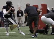 Texas A&M quarterback Johnny Manziel passes the ball during a drill at pro day for NFL football representatives in College Station, Texas, Thursday, March 27, 2014. (AP Photo/Patric Schneider)