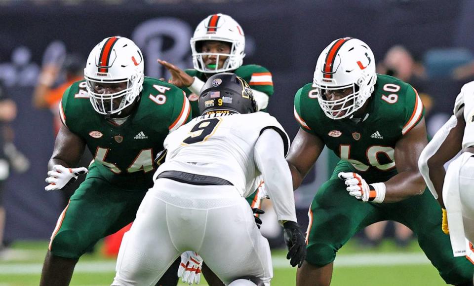 Miami Hurricanes offensive lineman Jalen Rivers (64) and Zion Nelson (60) protecting quarterback D’Eriq King (1) from Appalachian State Mountaineers defensive lineman Demetrius Taylor (9) during the first quarter of their ACC football game at Hard Rock Stadium on Saturday, September 11, 2021 in Miami Gardens, Florida.