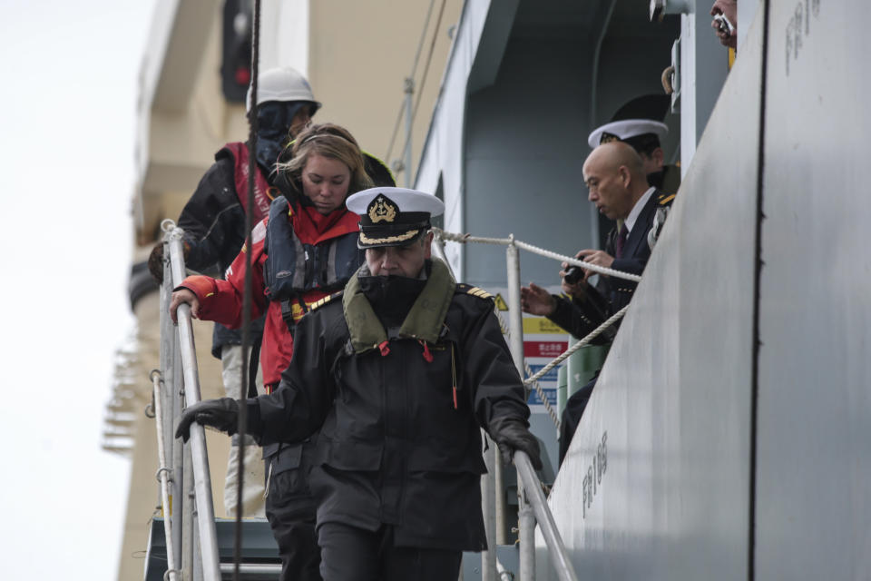 British solo sailor Susie Goodall disembarks the cargo ship MV Tian Fu in Punta Arenas, Chile, Friday, Dec. 14, 2018. The cargo ship rescued Goodall last week after a violent storm ripped off her mast and flung her yacht end over end in the Southern Ocean as she competed in a solo round-the-world race. (AP Photo/Joel Estay)