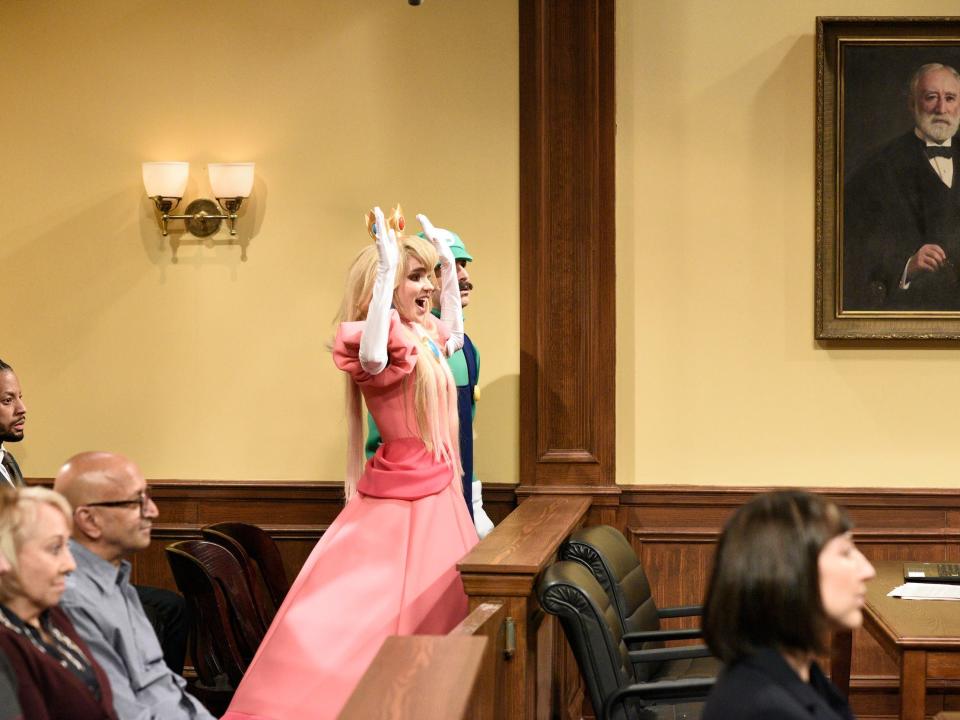 Grimes dressed as Princess Peach in a courtroom during Elon Musk's appearance on "Saturday Night Live"