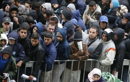 Migrants queue in the compound outside the Berlin Office of Health and Social Affairs (LAGESO) as they wait to register in Berlin, Germany, October 7, 2015. REUTERS/Fabrizio Bensch