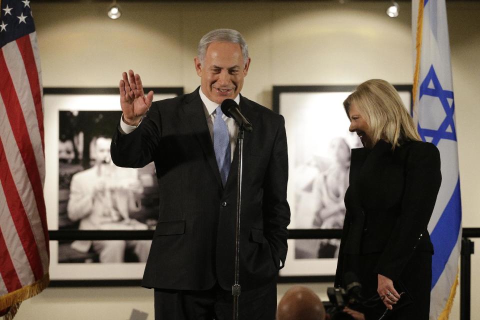 Israeli Prime Minister Benjamin Netanyahu, accompanied by his wife Sara, right, speaks before the screening of the television documentary "Israel: The Royal Tour" at Paramount Studios on Tuesday, March 4, 2014, in Los Angeles. Netanyahu flew Tuesday from Washington, D.C., to California, trading a focus on the geopolitics of the Middle East for a Hollywood screening and visits with Silicon Valley tech entrepreneurs.(AP Photo/Jae C. Hong)