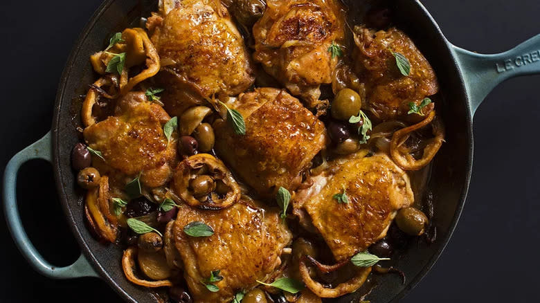 Chicken thighs and olives in pan