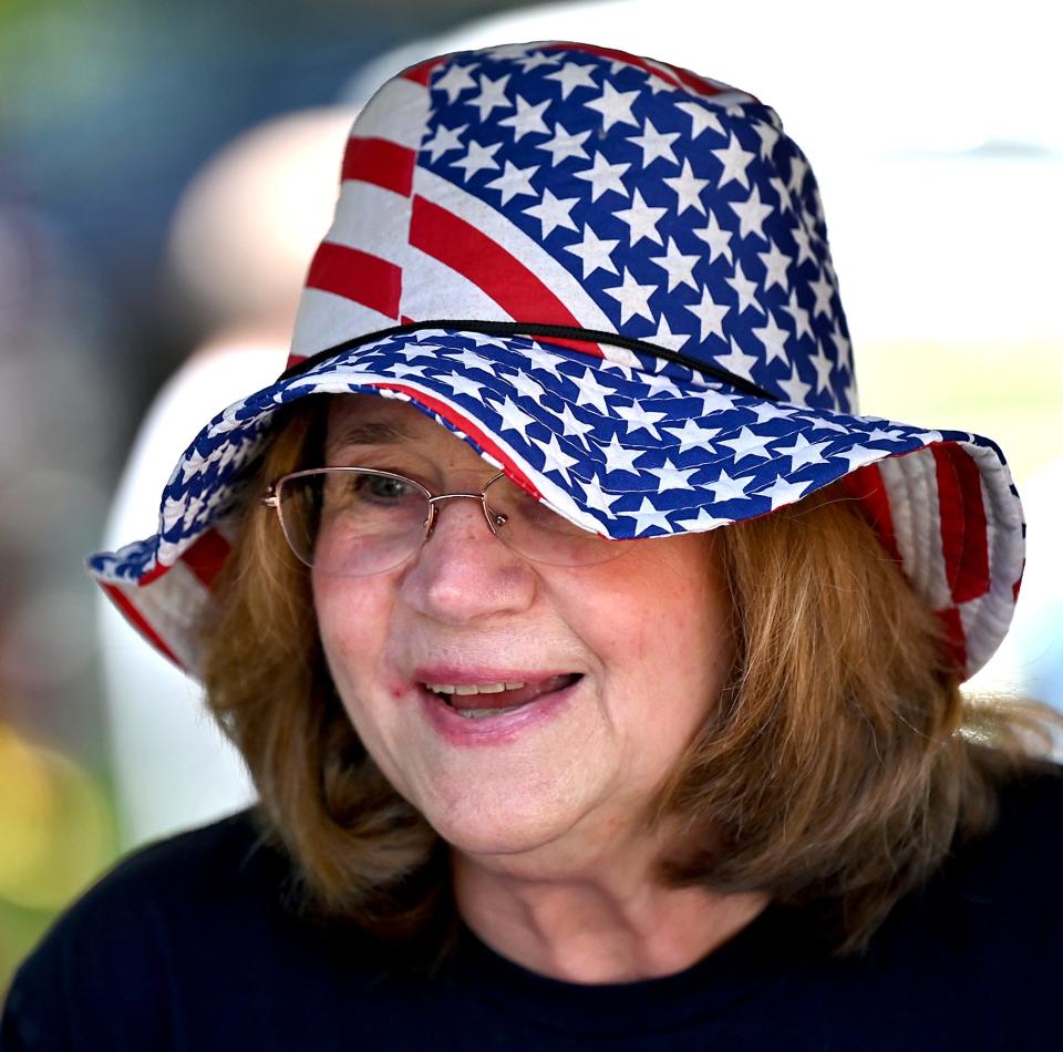 Christine Manns wears a patriotic hat while working the Franklin Democratic Town Commitee booth on the Franklin Town Common, July 2, 2022.