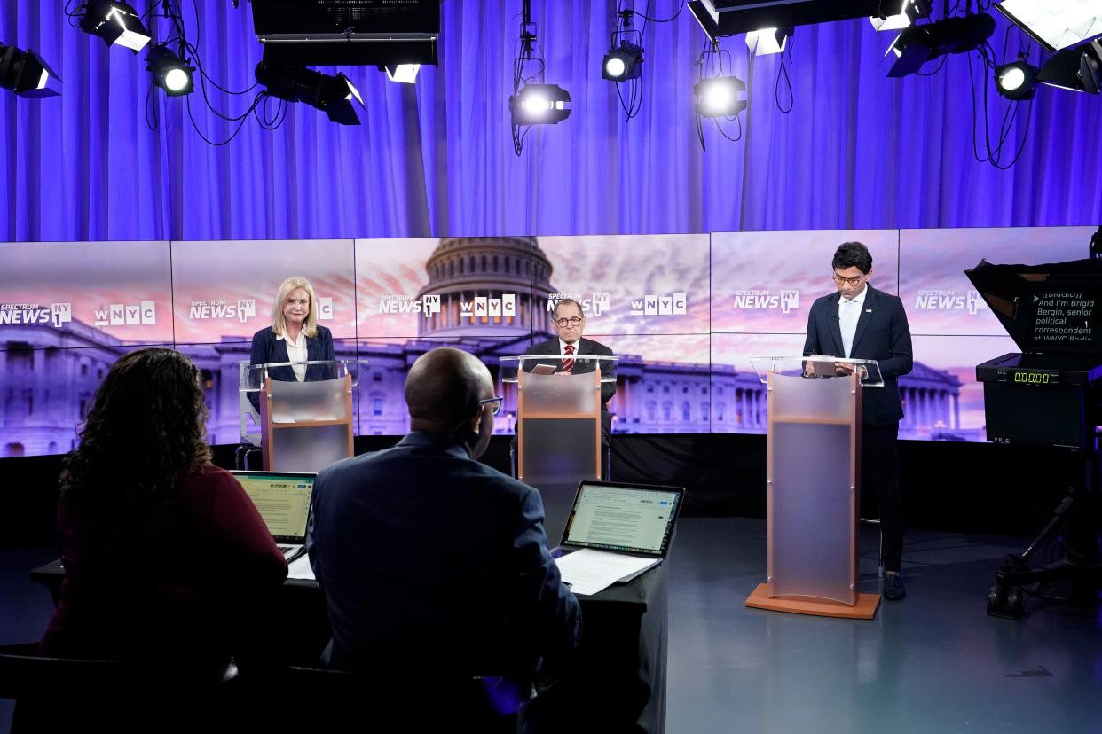 WNYC Senior Politics Reporter Brigid Bergin, foreground left, and NY1 Politics Anchor Errol Louis moderate as Rep. Carolyn Maloney, background left, Rep. Jerry Nadler, center, and attorney Suraj Patel debate during New York's 12th Congressional District Democratic primary debate hosted by Spectrum News NY1 and WNYC at the CUNY Graduate Center, Tuesday, Aug. 2, 2022, in New York. (AP Photo/Mary Altaffer, Pool)