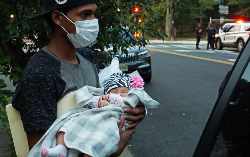 A one month old baby is placed into a vehicle for transport to a safe place (REUTERS)