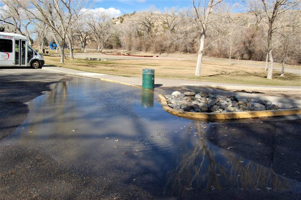 A puddle covers much of the parking lot at Kiwanis Park in Farmington on March 16.