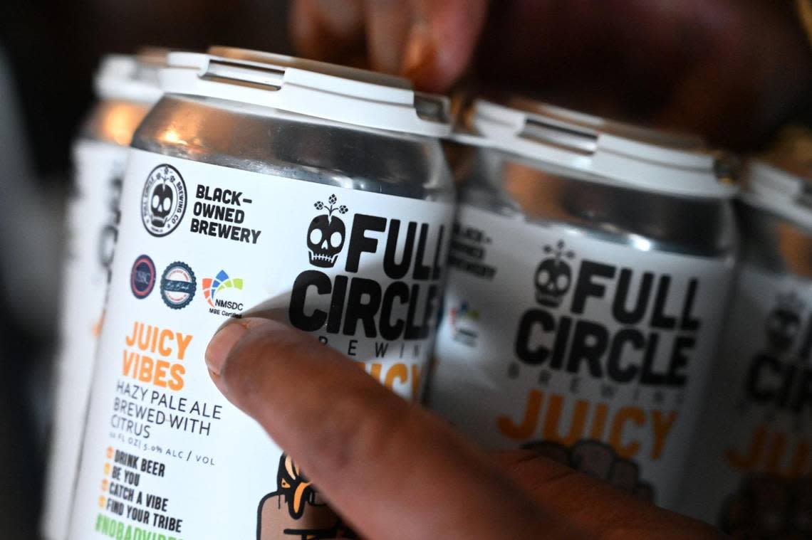Full Circle Brewing’s CEO Arthur Moye points out Black-owned labeling helping celebrate Black History Month Saturday, Feb. 4, 2023 in Fresno.