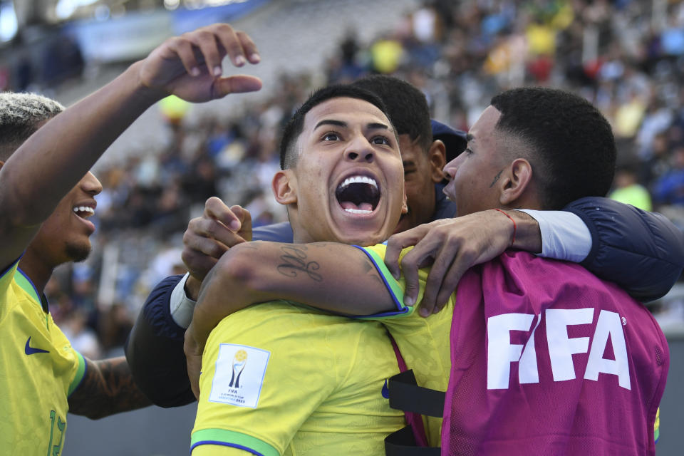 Brazil's Matheus Martins, center, celebrates with teammates after scoring his side's third goal against Tunisia during a FIFA U-20 World Cup round of 16 soccer match at La Plata Stadium in La Plata, Argentina, Wednesday, May 31, 2023. (AP Photo/Gustavo Garello)