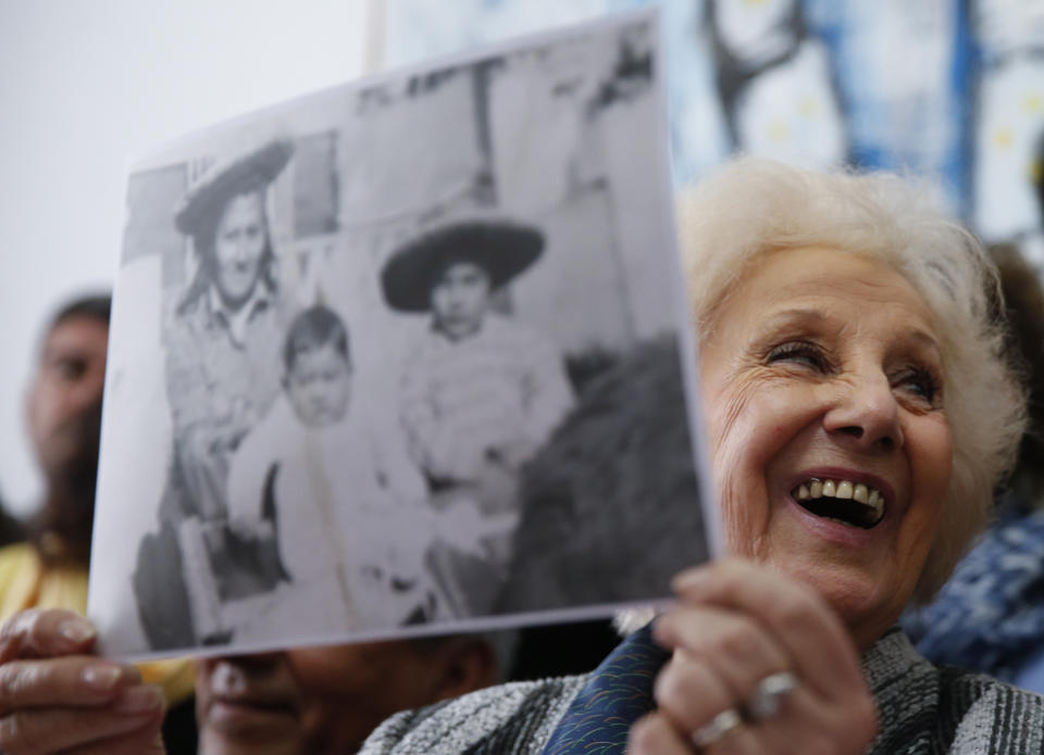 President of the Grandmothers of Plaza de Mayo human rights group, Estela de Carlotto, holds a photo of Rosario del Carmen Ramos, with two of her three sons Ismael, right, and Camilo, before she disappeared during Argentina's military dictatorship, in Buenos Aires, Argentina Friday, Aug. 3, 2018. The human rights group announced they found Rosario's other son Marcos Eduardo Ramos, who was kidnapped together with his brother Ismael in 1976 during the last military dictatorship in Argentina. (AP Photo/Natacha Pisarenko)
