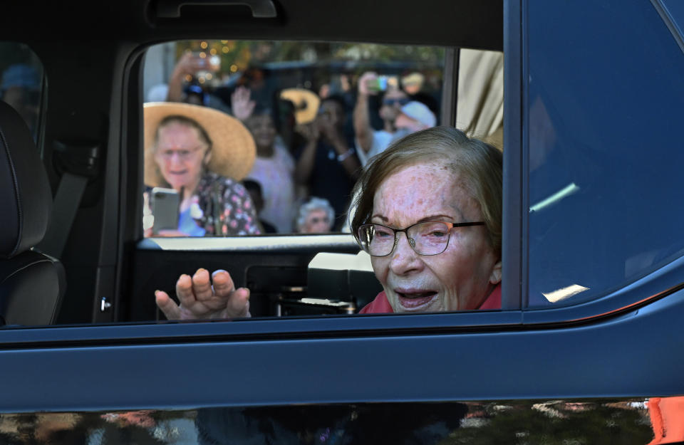 Rosalynn Carter waves to people lining the streets at the Peanut Festival Parade. 