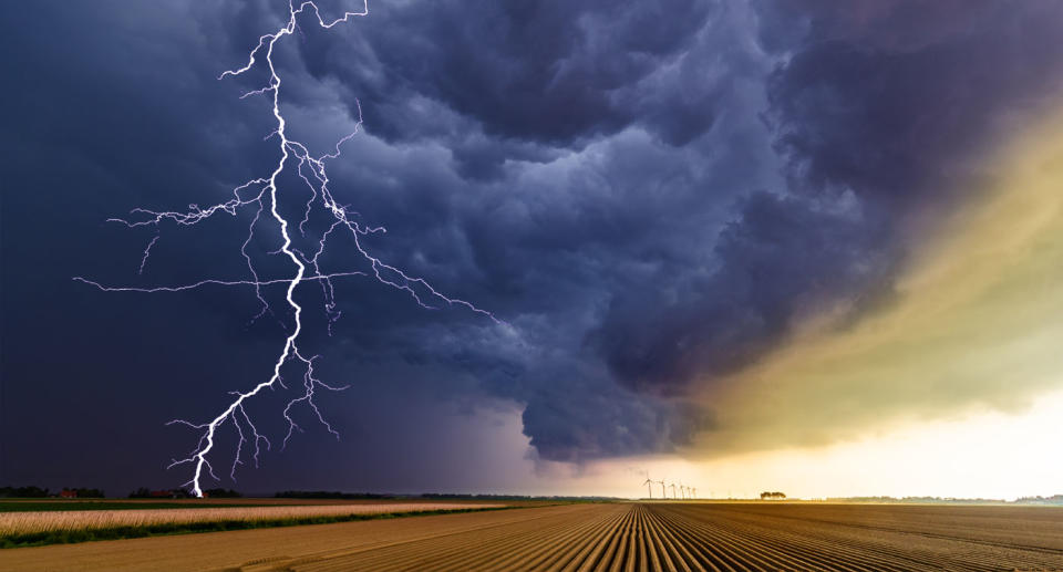 Lightning bolt hits field during a storm