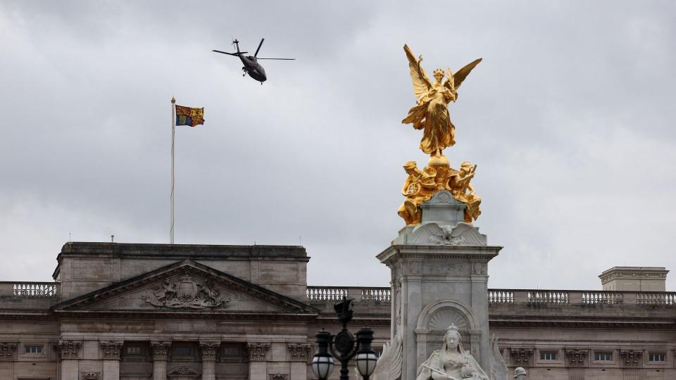 A helicopter is pictured taking off from the grounds of Buckingham Palace 