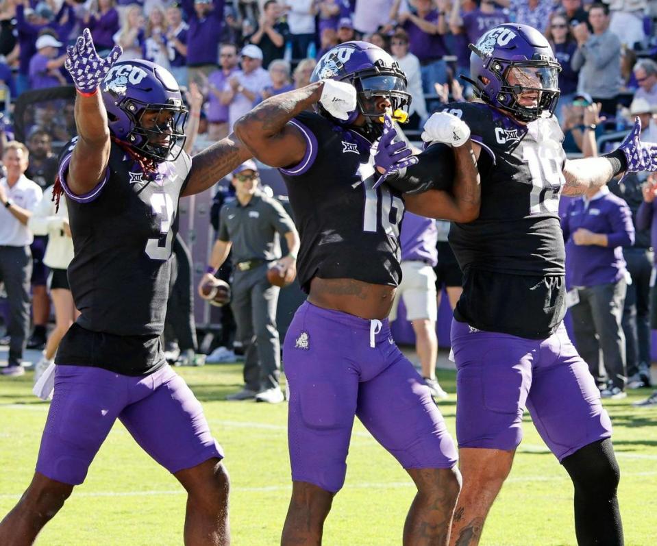 TCU wide receivers Savion Williams (3) and Dylan Wright (16) celebrate with TCU tight end Jared Wiley (19) after Wiley’s touchdown against BYU.