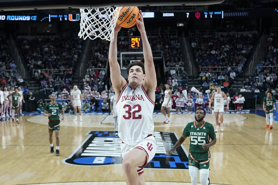 Indiana's Trey Galloway (32) dunks as Miami's Wooga Poplar (55) looks on in the first half of a second-round college basketball game in the NCAA Tournament, Sunday, March 19, 2023, in Albany, N.Y. (AP Photo/John Minchillo)