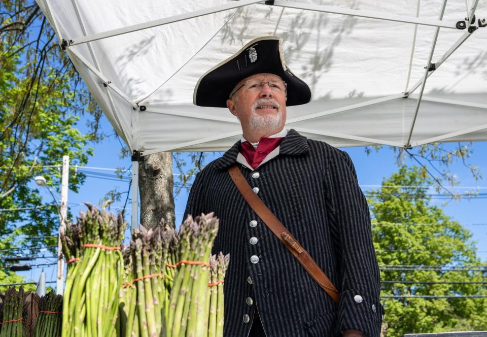 Rudy Arn roams West Brookfield Common during the annual Asparagus Festival as Dutchman Diederick Leertouwer.
