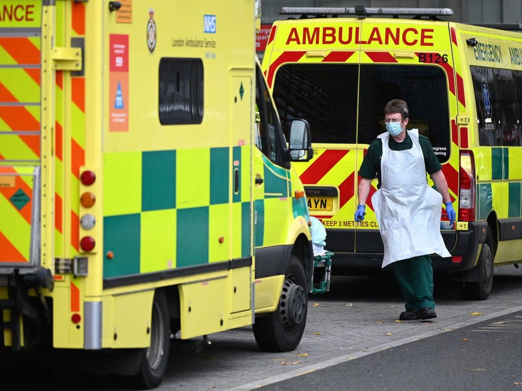 A paramedic walks past ambulances outside the Royal London Hospital (Daniel Leal/AFP via Getty Images)