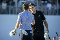 Ludvig Åberg, of Sweden, right, shakes hands with Mackenzie Hughes, left, after finishing on the 18th green during the final round of the RSM Classic golf tournament, Sunday, Nov. 19, 2023, in St. Simons Island, Ga. (AP Photo/Stephen B. Morton)