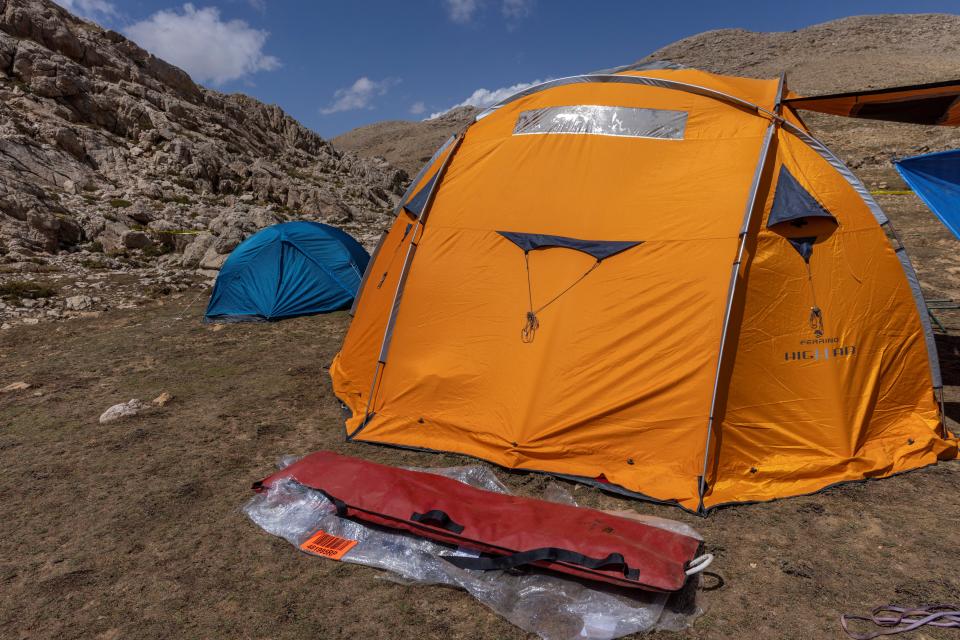 A stretcher is seen in front of a tent at the base camp for international rescuers near the Morca Cave (REUTERS)