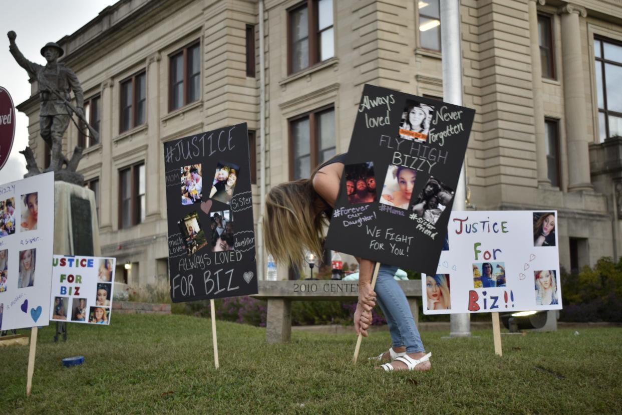 Vickie Edwards helps post signs in Spencer in September 2021 during a vigil at the Owen County Courthouse for Elizabeth "Business" Stevens, who was killed in Owen County.