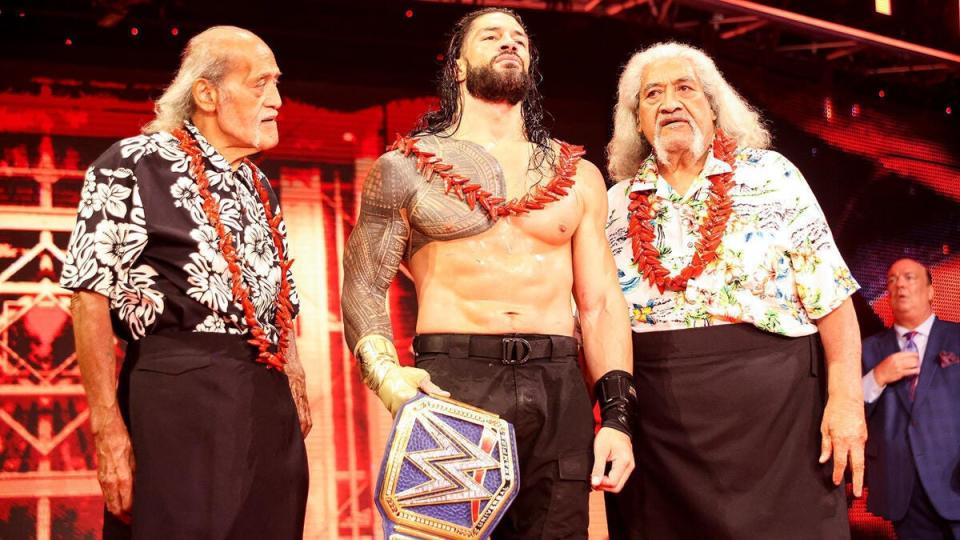 Roman Reigns celebrates his victory at Hell in a Cell 2020 with his uncle Afa Anoa'i (left) and father Sika Anoa'i (right).