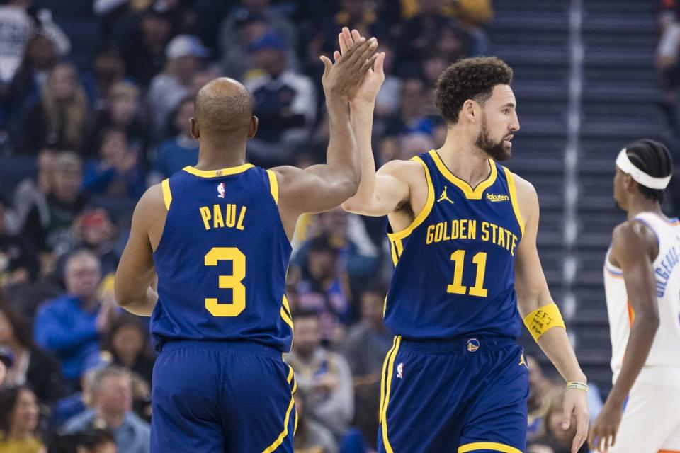 Nov 18, 2023; San Francisco, California, USA; Golden State Warriors guard Chris Paul (3) congratulates guard Klay Thompson (11) after he was fouled by a Oklahoma City Thunderâ€™s player during the first half at Chase Center. Mandatory Credit: John Hefti-USA TODAY Sports