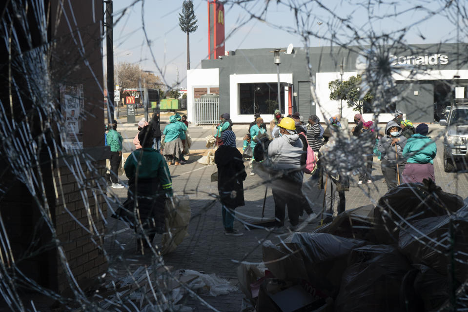 Volunteers participate in the cleaning efforts at Soweto's Diepkloof mall outside Johannesburg, South Africa, Thursday July 15, 2021. A massive cleaning effort has started following days of violence in Gauteng and KwaZulu-Natal provinces. The violence erupted last week after Zuma began serving a 15-month sentence for contempt of court for refusing to comply with a court order to testify at a state-backed inquiry investigating allegations of corruption while he was president from 2009 to 2018. (AP Photo/Jerome Delay)