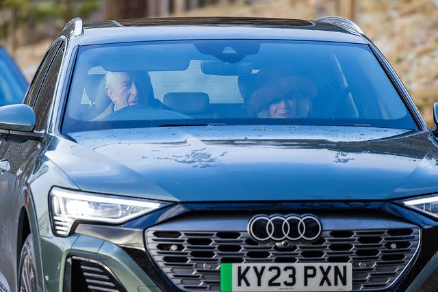 <p>Paul Campbell/PA Images via Getty Images</p> King Charles and Queen Camilla drive to Crathie Kirk, near Balmoral, on Jan. 14.