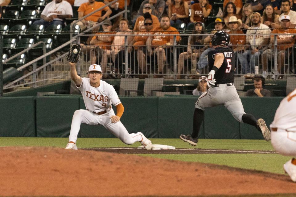 Texas first baseman Jared Thomas stretches for the putout during Friday night's win over Texas Tech.