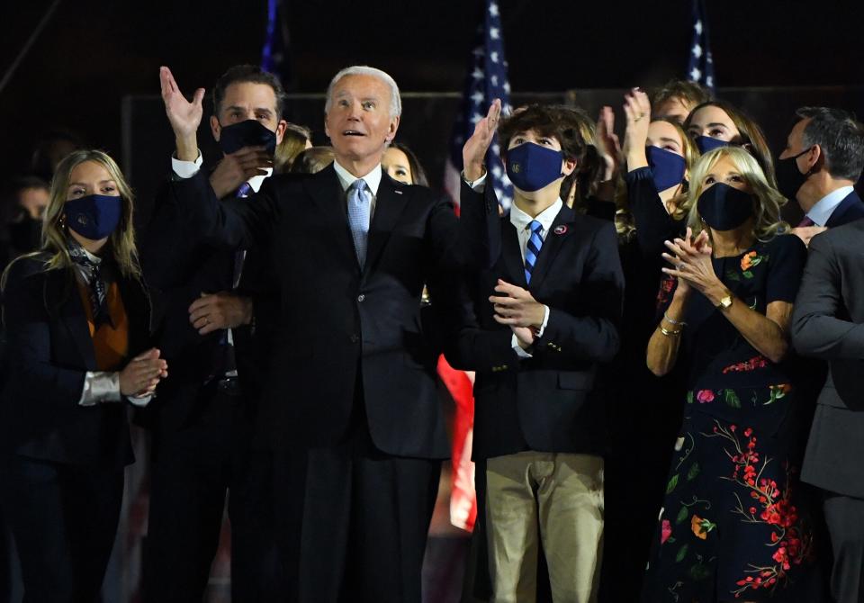 Joe Biden, center, and his family watch a fireworks display after delivering an address to the nation during an election event in Wilmington, Delaware, U.S., on Saturday, Nov. 7, 2020