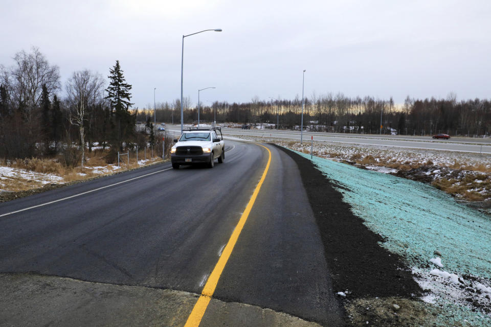 A pickup truck drives up a newly repaired off-ramp of Minnesota Drive on Wednesday, Dec. 5, 2018, in Anchorage, Alaska. A massive 7.0 earthquake and its aftershocks rocked buildings and buckled roads Nov. 30, including the ramp that's a route to Ted Stevens Anchorage International Airport. Alaska transportation officials made rebuilding the ramp a priority. It reopened Tuesday, Dec. 4, and a crew completed shoulder work Wednesday. (AP Photo/Dan Joling)