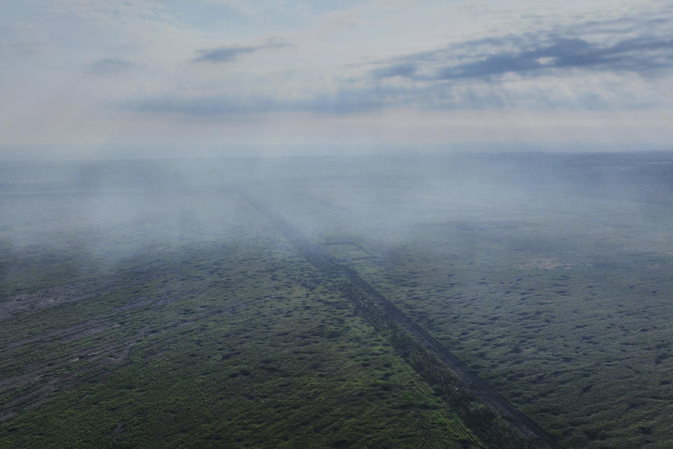 A field covered with bomb craters between the Ukrainian and Russian positions near Bakhmut, the site of fierce battles with the Russian forces in the Donetsk region, Ukraine, Sunday, Sept. 3, 2023. (AP Photo/Libkos)