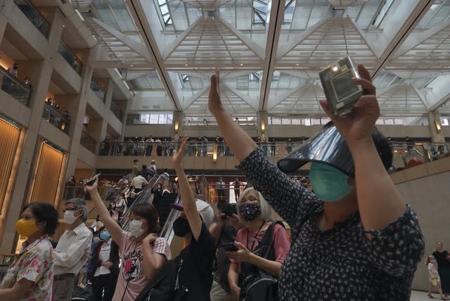 Protesters gesture with five fingers, signifying the “Five demands – not one less” (VIncent Yu/AP)