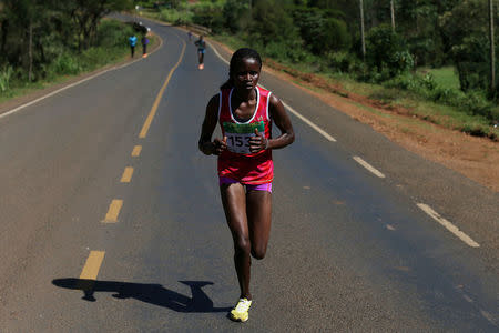 An athlete runs on a road during a half marathon near the town of Eldoret in western Kenya, March 20, 2016. REUTERS/Siegfried Modola